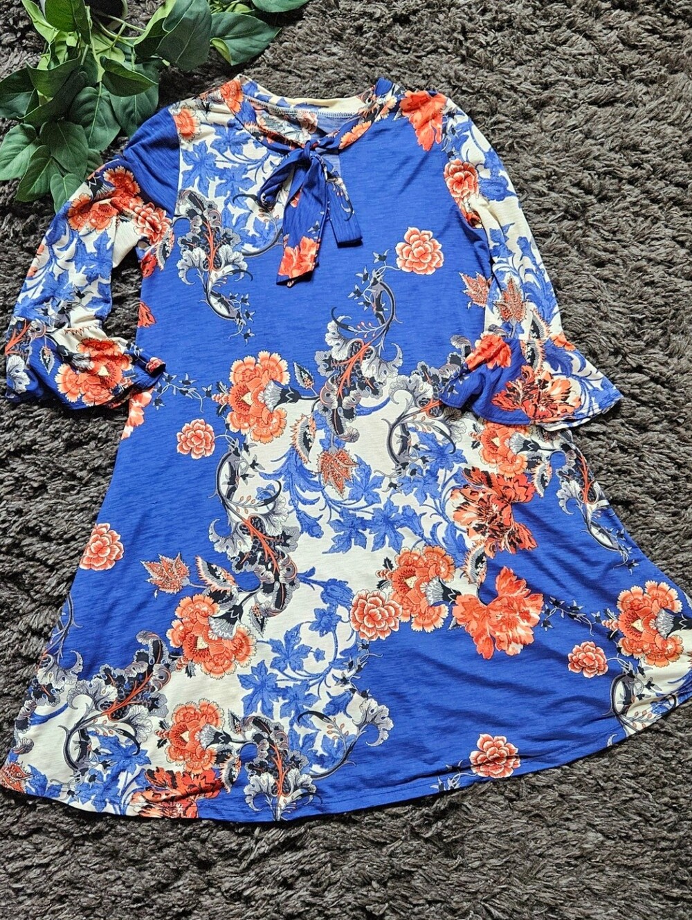 A-line tunic dress medium features a striking royal blue base decorated with a b